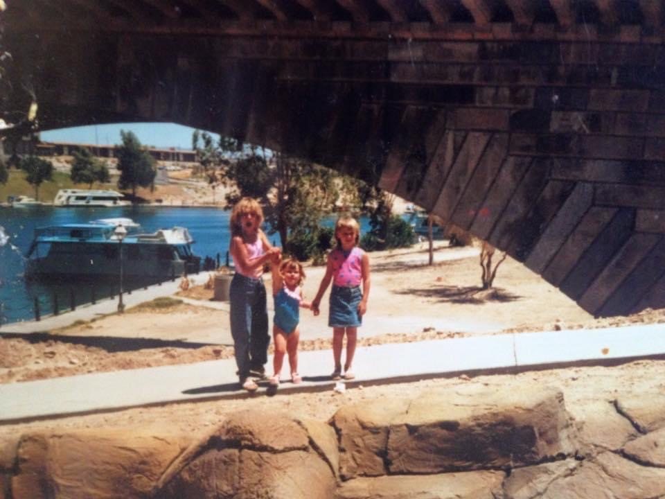 Us as children at Lake Havasu, standing on his work